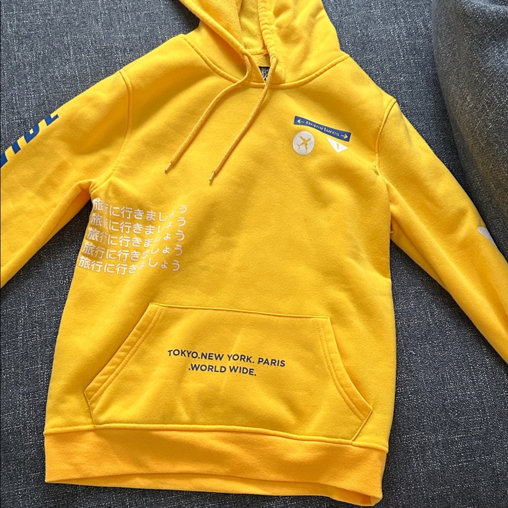 Yellow japenese letter plane hoodie has a tiny stain
